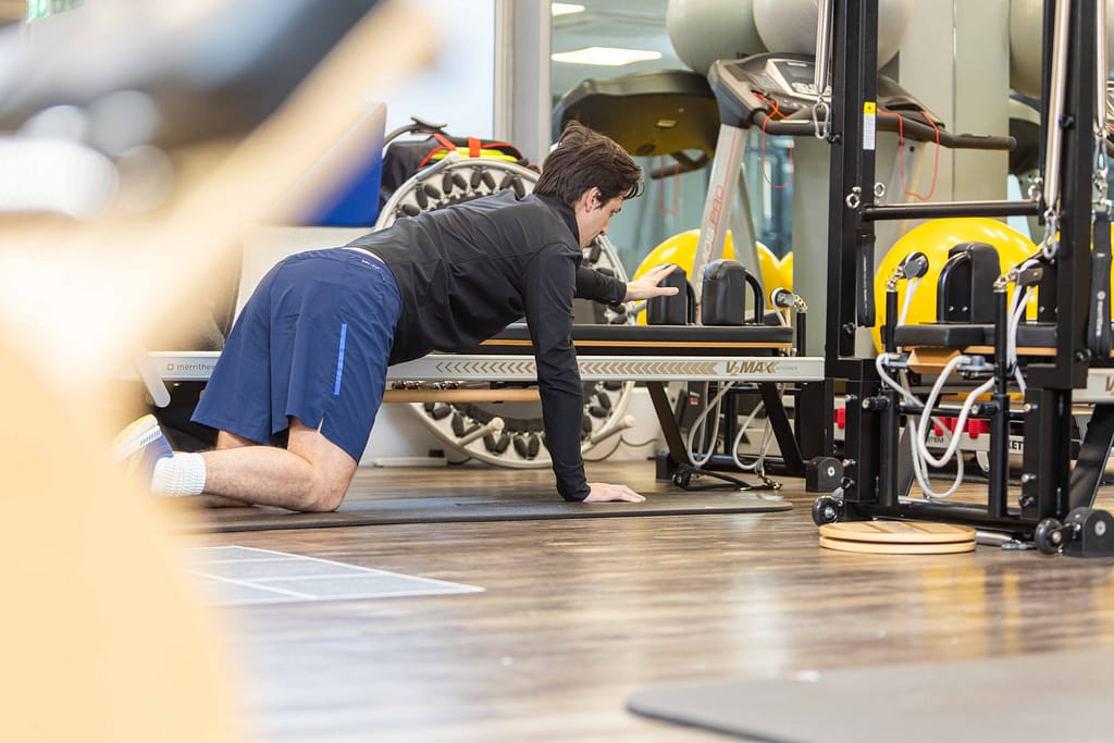 Male patient conducting Pilates exercise